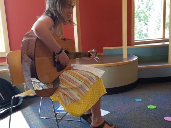 I'm sitting for a guitar performance at the Drake library, in astorytime event in town for kids