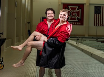 Me held up by my best friend Quinn near a Grinnell indoor swimming pool