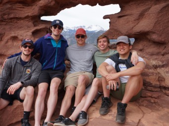 Me and my four friends are all wearing shades with backpacking gear in an opening in the Garden of the Gods - Colorado Springs, CO.