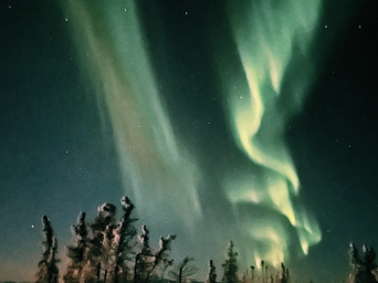 Beautiful green-lit lights in the Alaska sky
