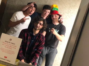 Me and my friends pose in front of a bathroom mirror, preparing for a Harris Party