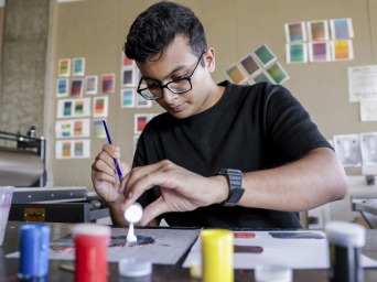 Parikshit works with paints in an art studio