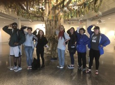 Chaz's group standing under fake art tree