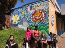 Chaz's page group of students in front of wall art on side of building 