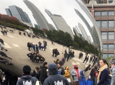 Crowd and buildings reflected in the bean