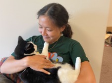 Justina holding a black and white cat
