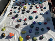 Rocks painted in bright colors arrayed on a table