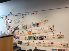 decorated manila folders hung on a wall labeled Warm and Fuzzy
