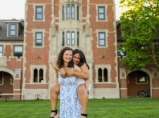 Eleanor and Maria in front of the iconic Grinnell Gates dorm tower.