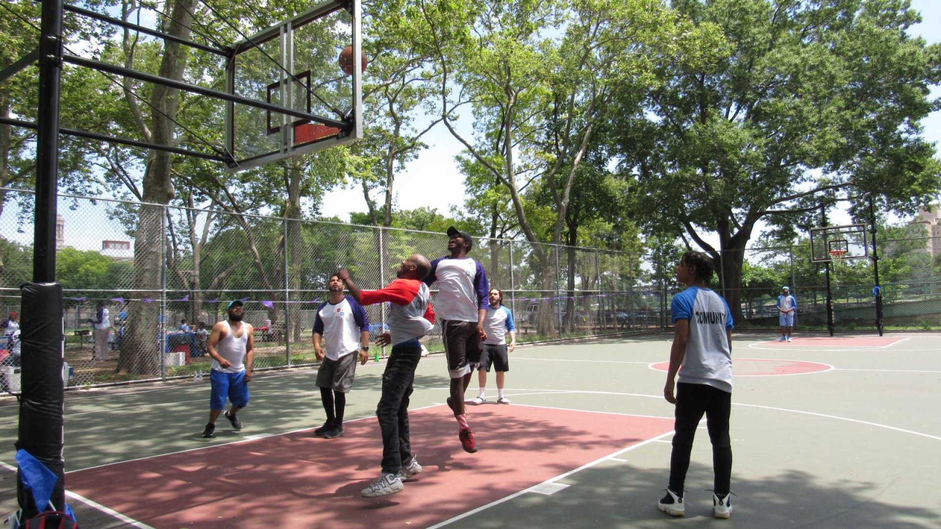 Chaz and community playing softball, and basketball