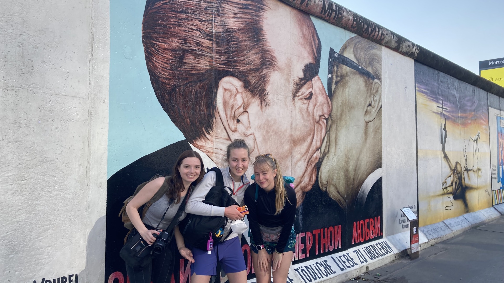 My classmates and I pose in front of the Berlin Wall graffiti
