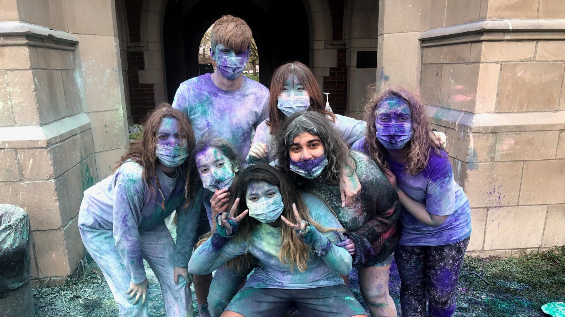 My friends and I drenched in paint head to toe near the arch of a residence hall building!