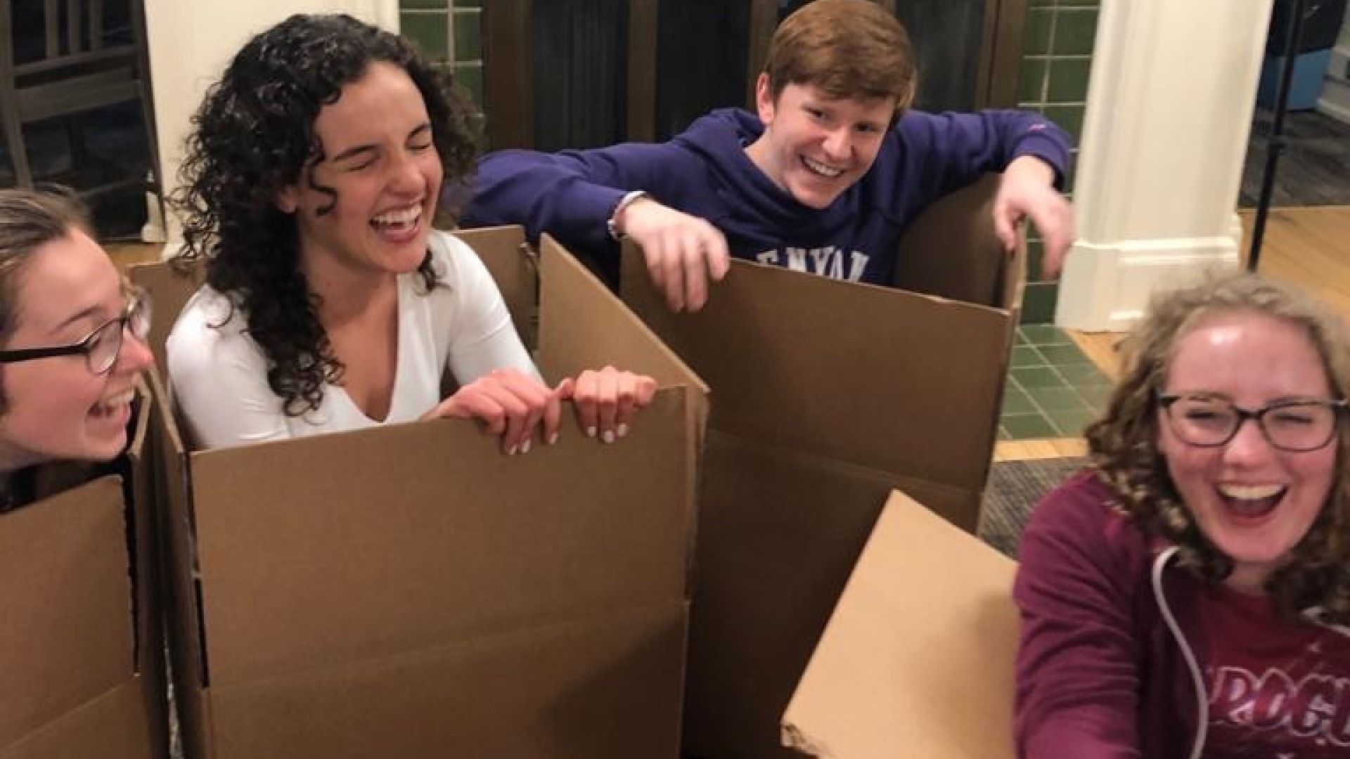 My friends and I are all inside boxes and trying to move, but laughing