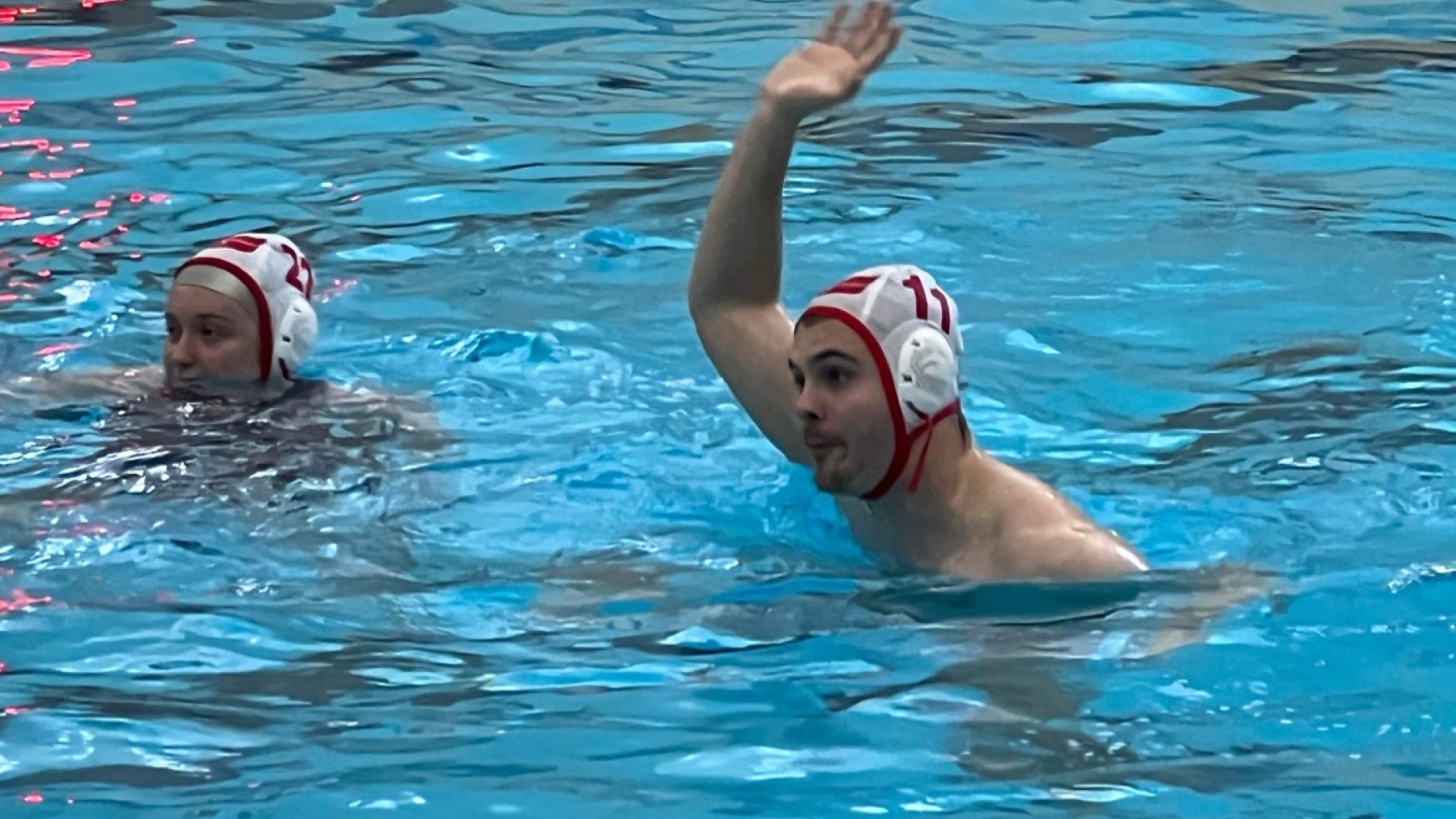 Me in a swimming pool, raised hand to catch the ball for water polo