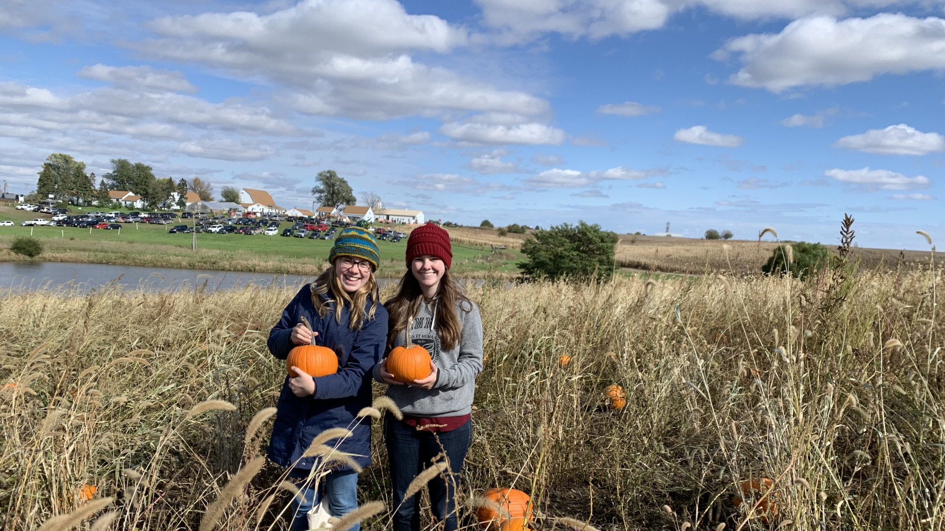 Me and Charis at the pumpkin patch, posing with our matching pumpkins
