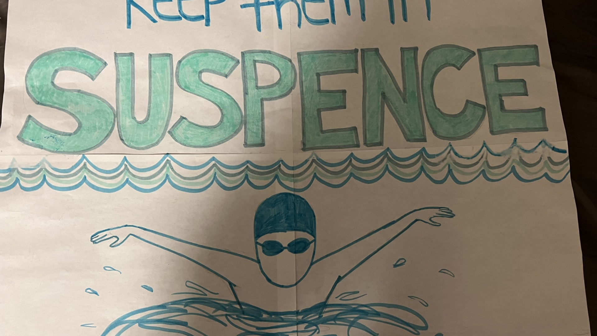 A drawing written in green that says "Keep the Suspence"