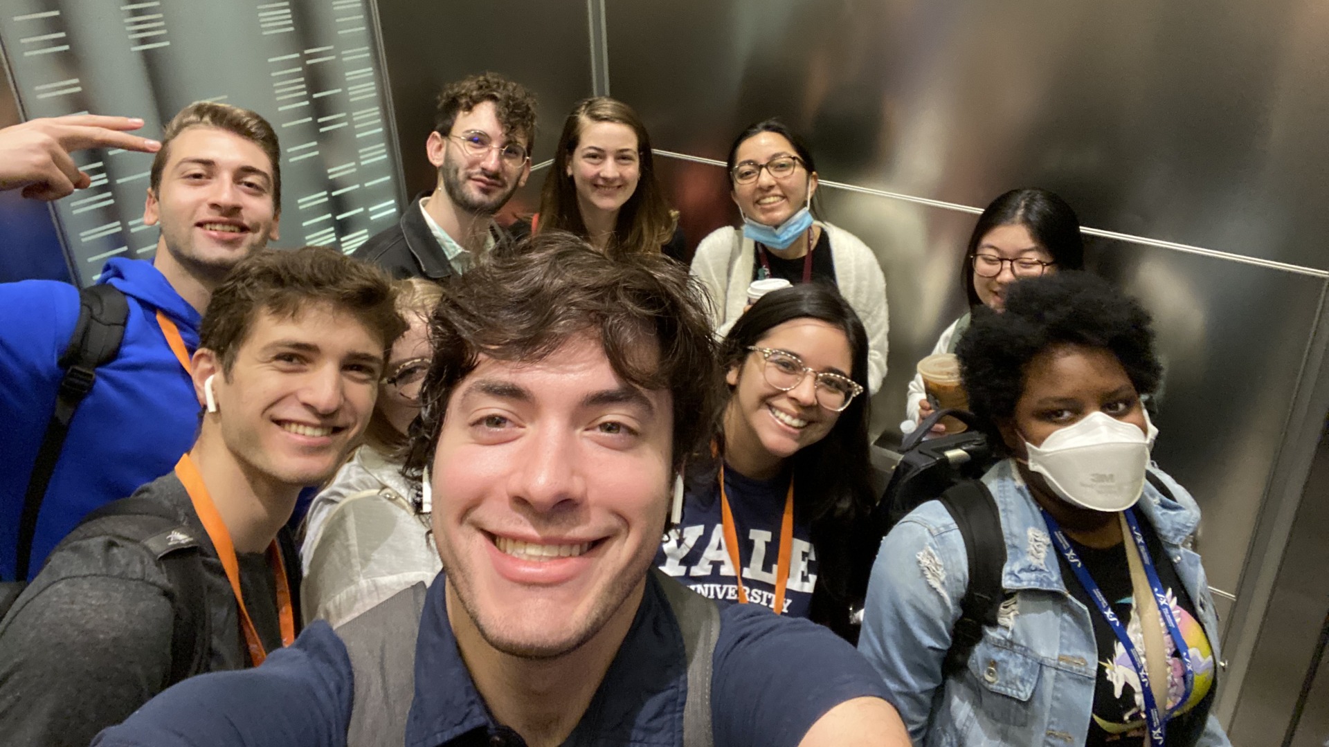 Me and my research colleagues smiling in the building elevator together