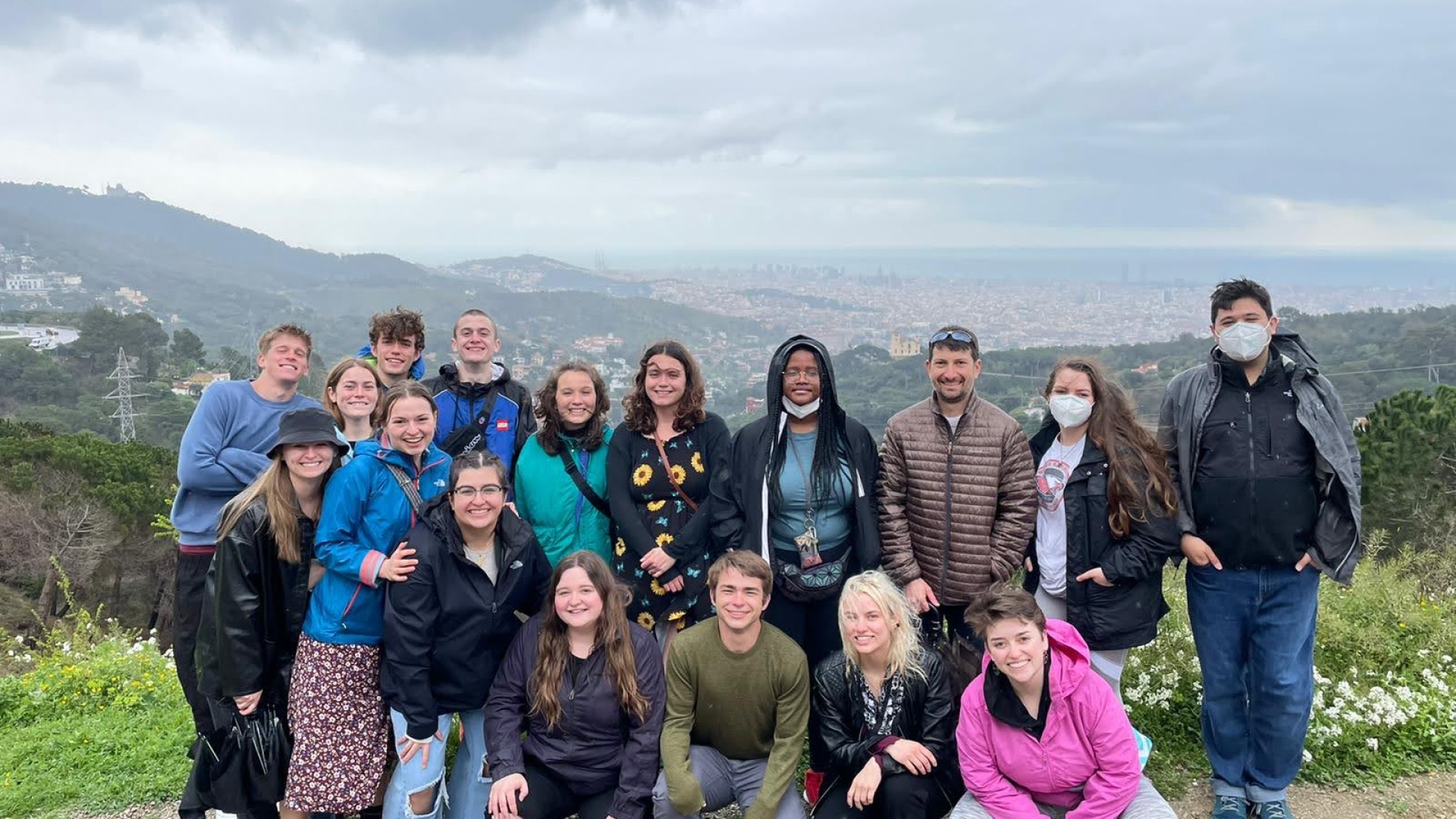 Sophie's course-embedded travel class smiles on top of a mountain in Spain.