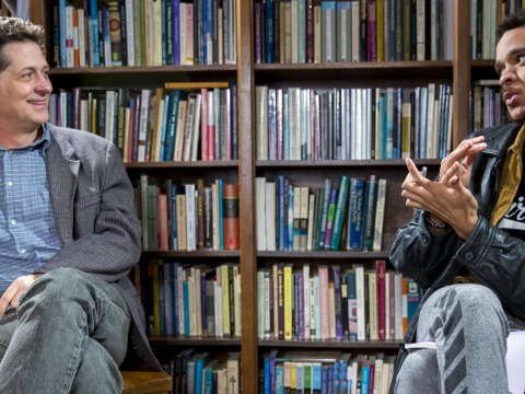 Professor Tyler Roberts and student Jermaine Stewart-Webb discussing tutorials