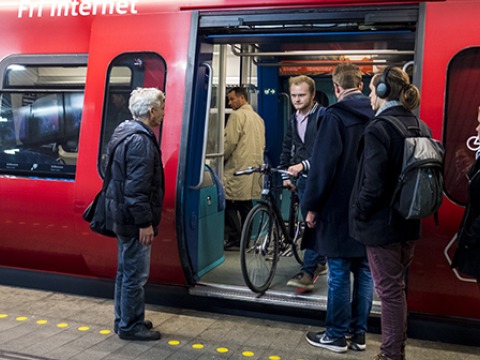 student with bike leaving Copenhagen train