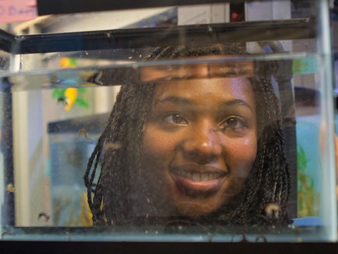 Amanda Hodo stands behind an aquarium