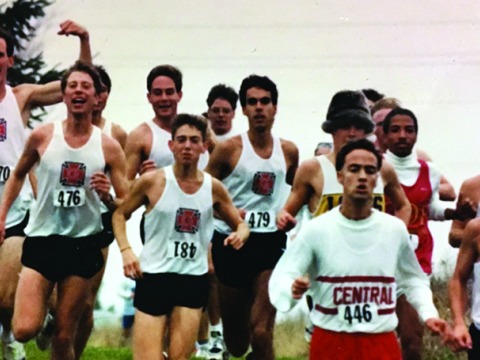 Group of running men in white tanks with honor g on front 