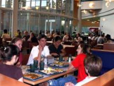 With dinner finished, students chat over their empty dining hall trays