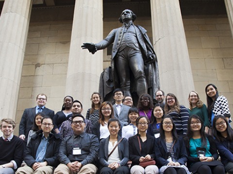 group at the foot of a statue