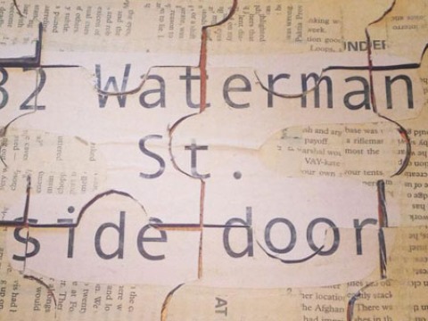 newspaper with large text reading 82 Waterman St. side door is cut into puzzle pieces