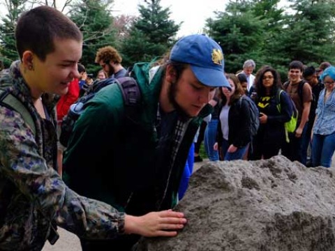 Students read the peace rock. 