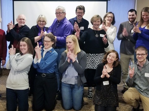 group holding their hands in finger guns