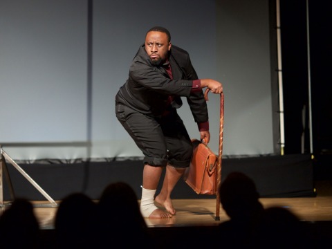 Still from performance of Kafkas Ape shows actorn with case and cane