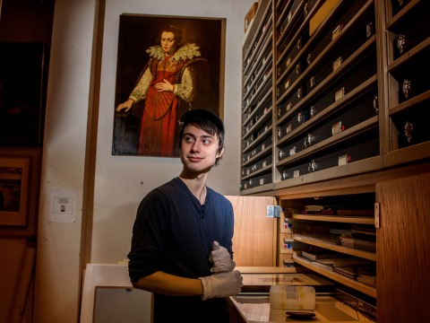 Owen Daley ’20 looking at different pieces in the Print and Drawing study room