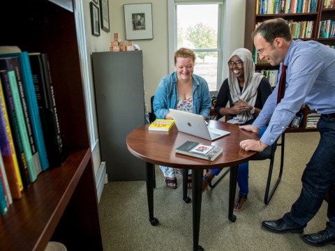 Unidentified student with Farah Omer and Caleb Elfenbein