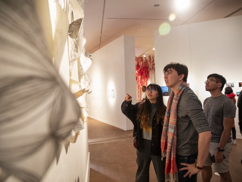 Guest discuss art hung on the Faulconer Gallery's wall