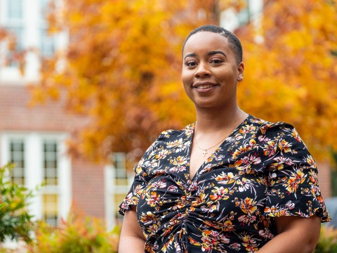 Alexandra Odom ’16 in front of a tree with autumn leaves