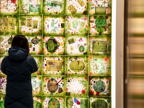 Student stands in front of art installation in HSSC