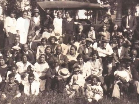 Family in front of car