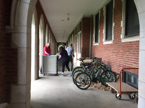 Americorps volunteers deliver meals in the loggia