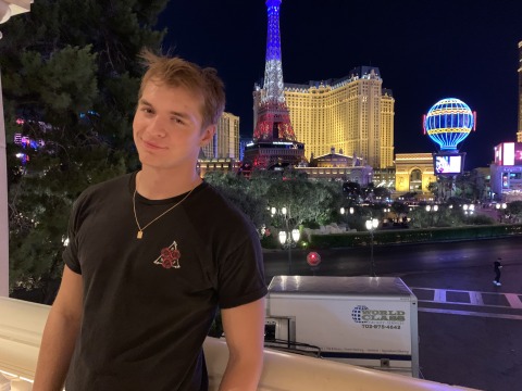 Matas smiles at the camera with brightly lit buildings in the background. It's my hometown, Las Vegas, NV.