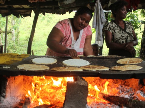Carmen Domínguez flips casabe (manioc flatbread) on her burén (griddle) near Manabao in the Dominican Republic.