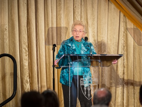 Celina Karp Biniaz speaks at a podium