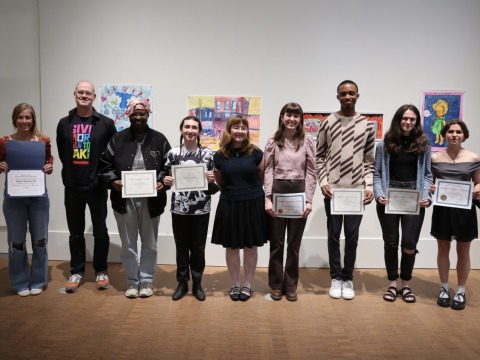 students at art museum standing in a line