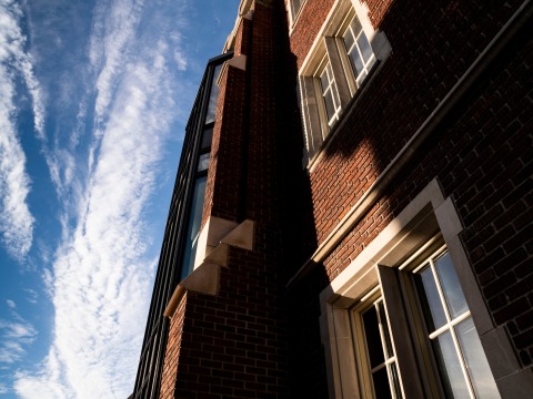 sun shining on building with blue sky