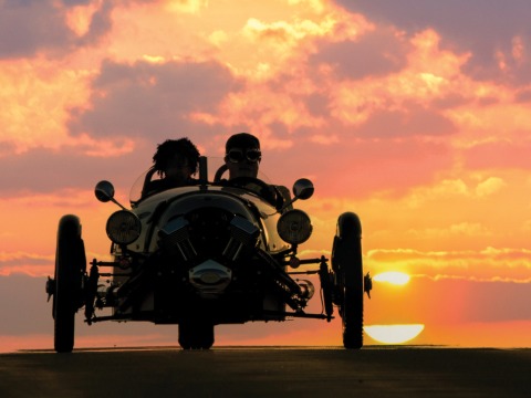 Scott and Freeman ride in his car silhouette by the setting sun