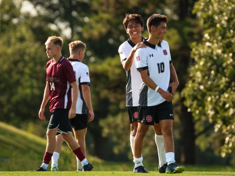 Soccer players cheer.