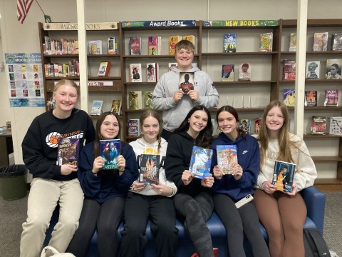 Grinnell High School Students Holding Up Books