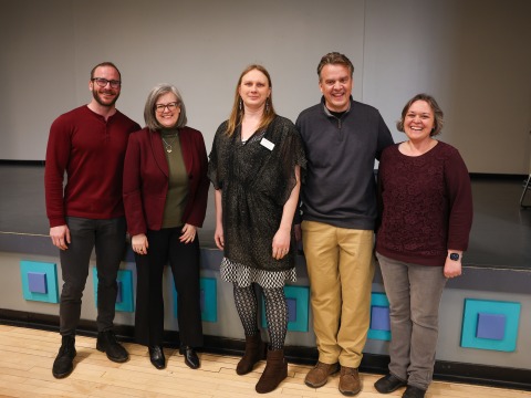 5 people standing in front of a stage in Harris 