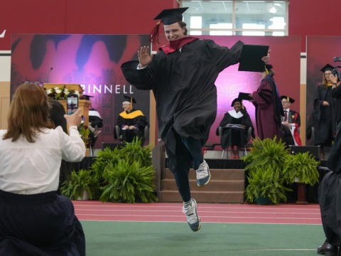 Student Skipping off Stage