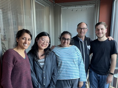 Professor Mark Levandoski, two current Grinnell students, and two alumni pose for a photo